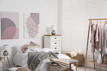 Teen's room interior with modern furniture and beautiful pictures on wall