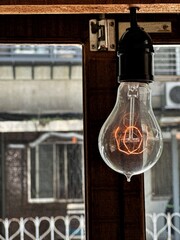 Vintage light bulb illuminating an ancient home