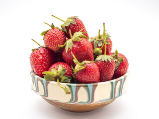 a large bowl filled with fresh strawberries on a table