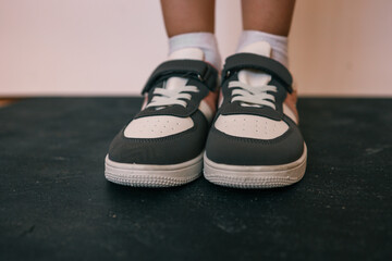 Children's sneakers on a pink background, style and fashion