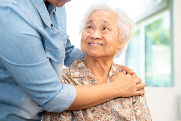 Caregiver help and care Asian senior woman patient with love, encourage and empathy in hospital.