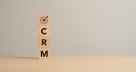 CRM, Customer relationship management concept. Customer satisfaction, retention strategies. CRM or customer loyalty program banner. Wooden cube blocks with CRM symbols on minimal background.