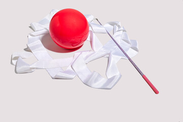Pink ball and white ribbon for rhythmic gymnastics on a white background. Rhythmic Gymnastic equipment