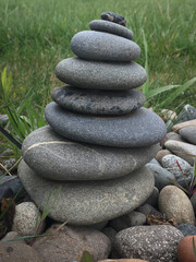a pile of pebbles sit among some rocks on the ground
