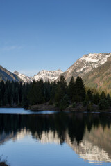 a body of water with a mountain in the background and trees on both sides