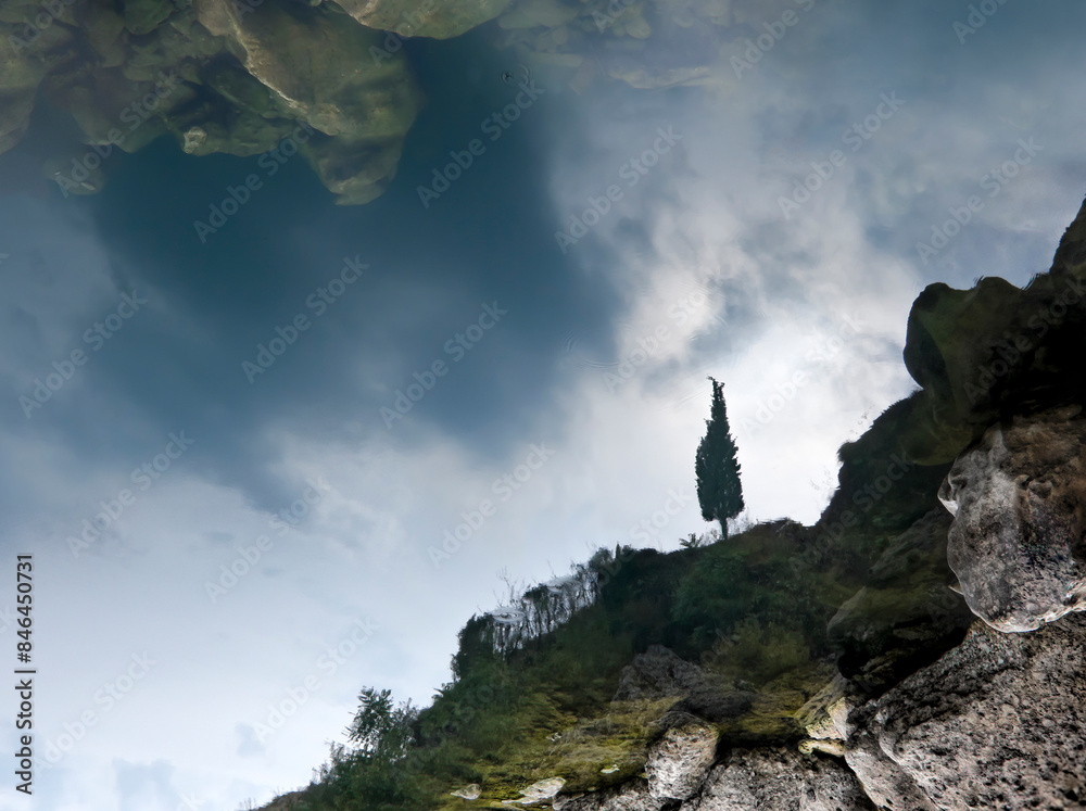 Canvas Prints a tower stands on the side of a cliff, above some trees