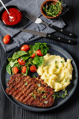 grilled pork steak with mashed potato and salad