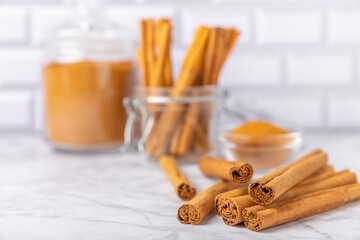 Ceylon cinnamon.Cinnamon sticks on a textured wooden background. Cinnamon roll and powder. Spicy spice for baking, desserts and drinks. Fragrant ground cinnamon. Close-up. Place for text. copy space