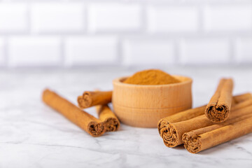Ceylon cinnamon.Cinnamon sticks on a textured wooden background. Cinnamon roll and powder. Spicy spice for baking, desserts and drinks. Fragrant ground cinnamon. Close-up. Place for text. copy space