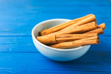 Ceylon cinnamon.Cinnamon sticks on a textured wooden background. Cinnamon roll and powder. Spicy spice for baking, desserts and drinks. Fragrant ground cinnamon. Close-up. Place for text. copy space