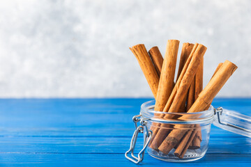Ceylon cinnamon.Cinnamon sticks on a textured wooden background. Cinnamon roll and powder. Spicy spice for baking, desserts and drinks. Fragrant ground cinnamon. Close-up. Place for text. copy space