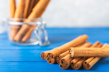 Ceylon cinnamon.Cinnamon sticks on a textured wooden background. Cinnamon roll and powder. Spicy spice for baking, desserts and drinks. Fragrant ground cinnamon. Close-up. Place for text. copy space