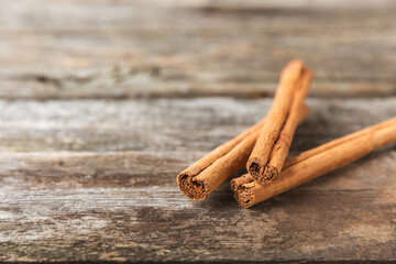 Ceylon cinnamon.Cinnamon sticks on a textured wooden background. Cinnamon roll and powder. Spicy...