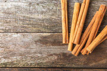 Ceylon cinnamon.Cinnamon sticks on a textured wooden background. Cinnamon roll and powder. Spicy spice for baking, desserts and drinks. Fragrant ground cinnamon. Close-up. Place for text. copy space
