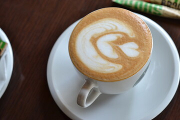 Latte on saucer with chocolate