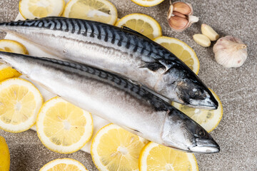 Uncooked mackerel sea fish with lemons and garlic, culinary recipe