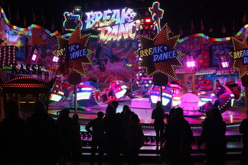 Festival Carnival party with Music, band show, singer, DJ, Neon lights, carrousel, toy