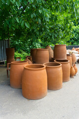 Several clay barrels of different sizes for baking bread are called tone