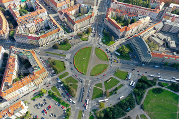 Drone view of an urban intersection with numerous streets and buildings