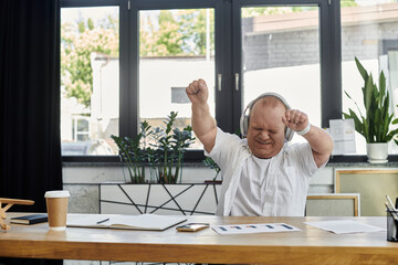 Fototapeta premium A man with inclusivity dances in his office, enjoying a break from work.