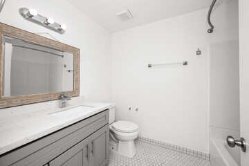 a very small bathroom with a white toilet sitting under a large mirror