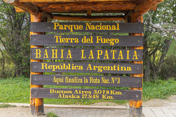 Sign indicating the end of the Pan American highway at Lapataia Bay in the Tierra del Fuego national Park. Selective focus on the sign