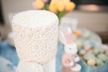 Closeup shot of fondant daisies decorating a delicious cake