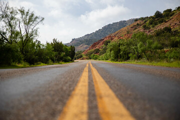 the road is yellow with a line of black stripes down the middle of the road