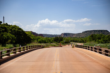 a street bridge in the desert with mountains in the background