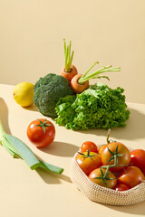 High angle shot of vegetable theme photo over light yellow background, several types of fresh vegetable featured on countertop. Blank space for advertising and designing