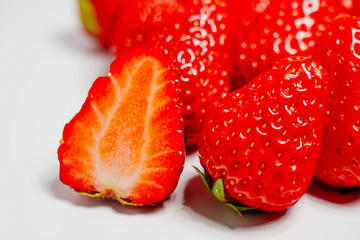 Closeup photo of red strawberry against white background © Kem