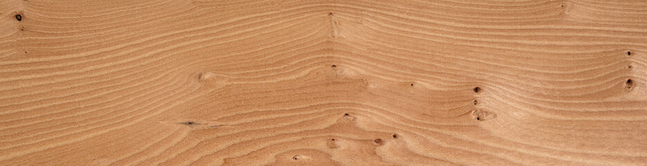 Warm Eibe veneer wood surface showcasing natural whorl patterns and knots