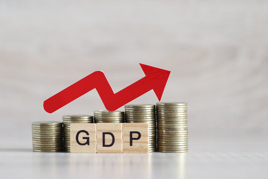 Red arrow on coins money and gdp word on wooden background, GDP (Gross Domestic Product) concept