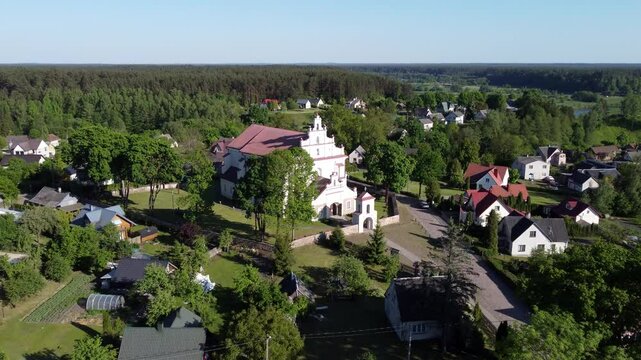 Aerial view of Merkine, Lithuania, highlighting the Merkine Church of Saint Mary of the Assumption.