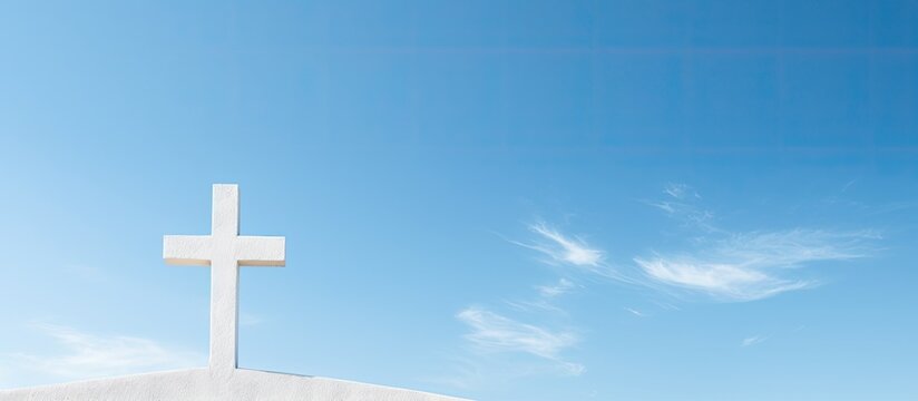 Copy space image of a cross on a church building against a backdrop of a clear blue sky representing the background of Christianity