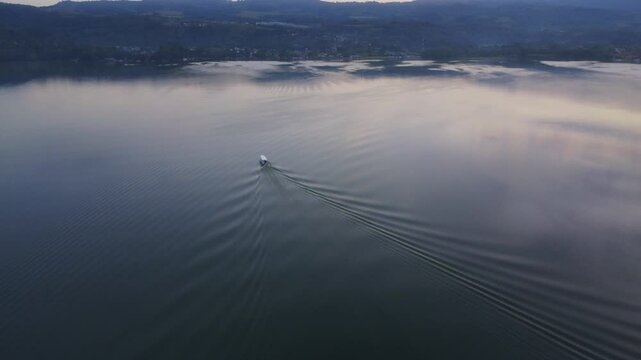 Drone gracefully glides over the Blue Lagoon in Tarapoto, Peru, as the sun sets