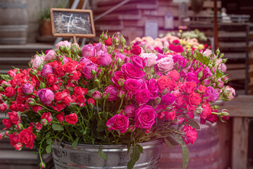 a bucket of fresh-cut roses multicolored