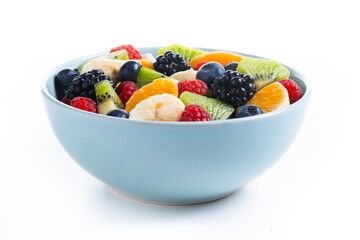 Fruit salad in a blue bowl isolated on white background