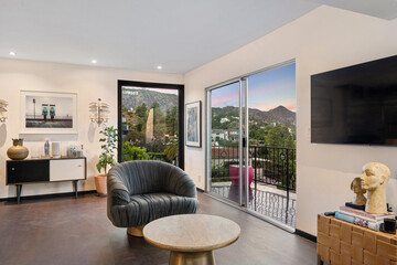 Fototapeta premium Spacious living room with hardwood floors and tall windows. Los Angeles, California