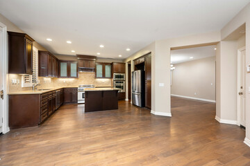 Spacious kitchen with hardwood floors and brown cabinets. California, USA