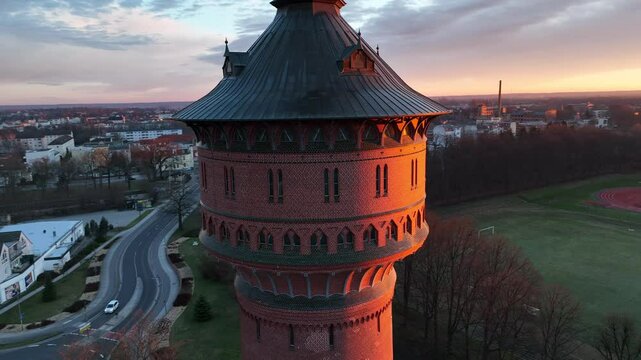 Drone footage of the historical Water Tower (Wasserturm) at sunrise in Forst (Lausitz) town, Germany