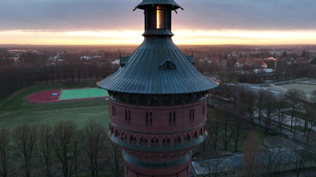 Drone footage of the historical Water Tower (Wasserturm) at sunrise in Forst (Lausitz) town, Germany