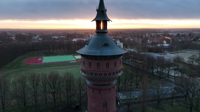 Ascending drone footage of the historical Water Tower (Wasserturm) at sunrise in Forst town, Germany