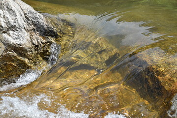 Mountain river flow over stones close-up.