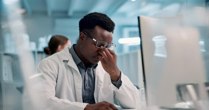 Science, computer and black man with eye pain in lab for vaccine study, brain fog and headache. Frustrated, scientist and stress with digital technology for stem cell, medical research and report