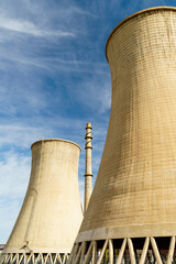 Giant cooling tower in a factory in blue sky background from different perspectives