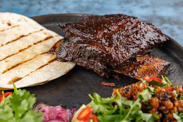 ribs BBQ, greens, pita bread. Restaurant serving