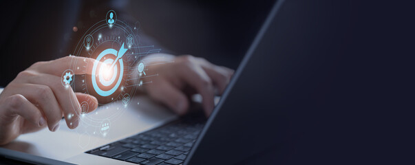Digital marketing. Businessman touching darts aiming at the target center