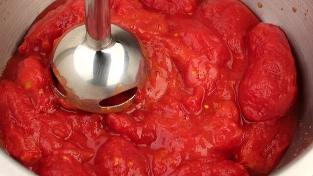 Process grinding tomatoes with a blender before cooking sauce or soup