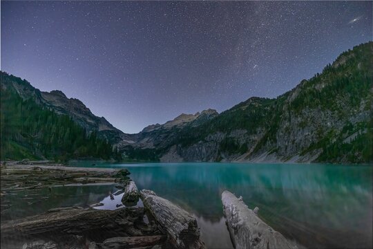 Scenic view of the turquoise Blanka Lake surrounded by trees and mountains, in Washington